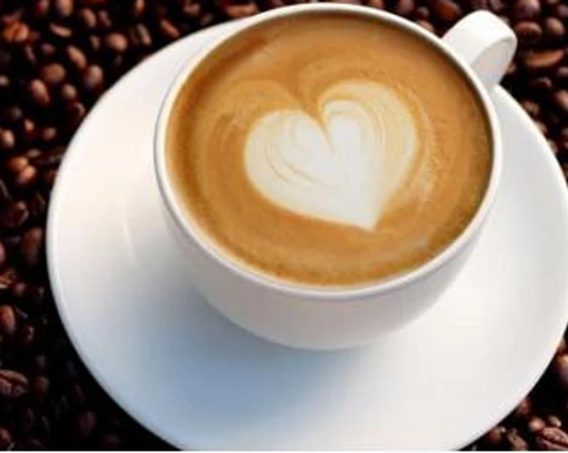 Heart-shaped latte art on coffee beans